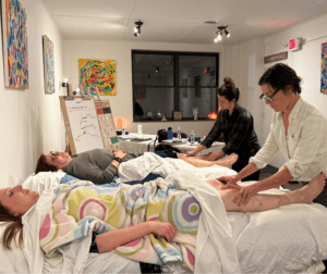 Students learning advanced reflexology lymph drainage protocols